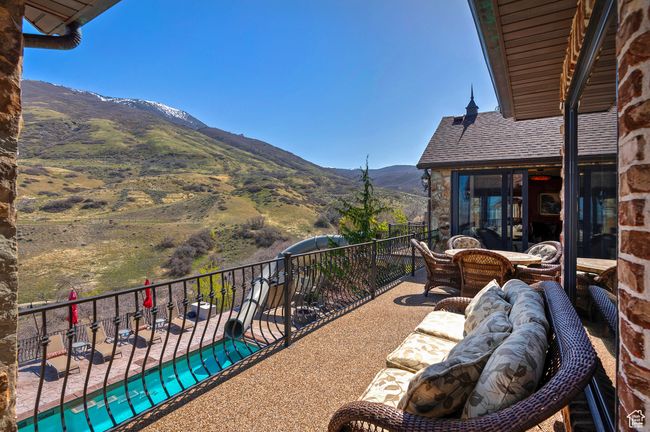 Balcony with a mountain view and an outdoor living space | Image 13