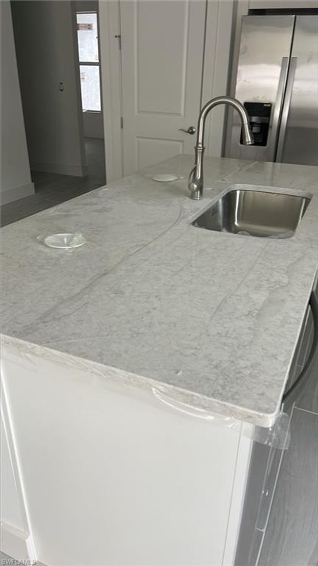 Quartz countertops and stainless steel Kohler, farmhouse sink and pull-down faucet | Image 5