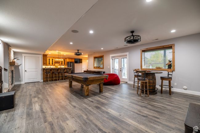 Game room featuring a bar, billiards table, dark wood-style flooring, recessed lighting, and french doors | Image 52