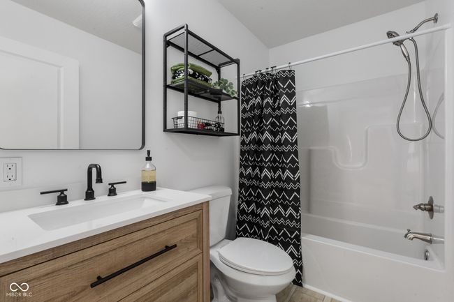 full bath with shower / tub combo, vanity, and toilet | Image 40