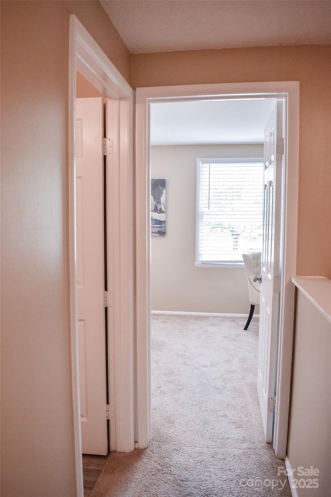 Entrance to the primary bedroom. Door on the left leads to the upstairs bathroom. | Image 11