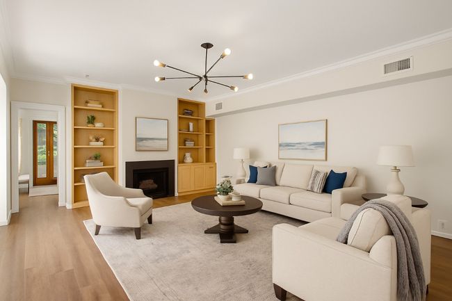 Virtually staged to show different styling. Built in bookshelves and designer picked light fixture along with a gas fireplace. | Image 5