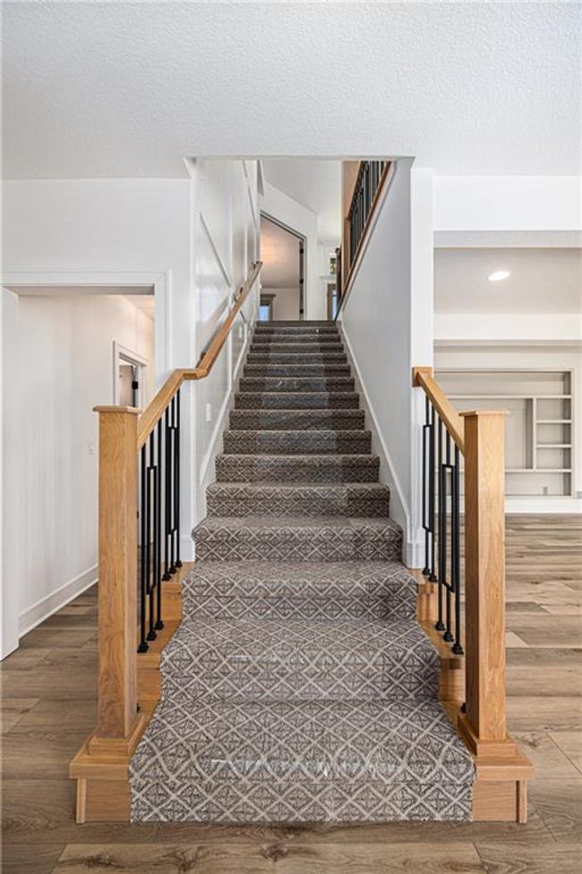 Staircase featuring wood finished floors and baseboards | Image 8