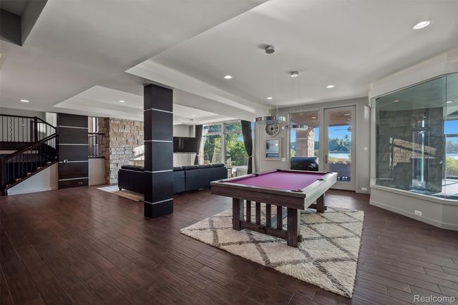 Rec room featuring billiards, a raised ceiling, dark wood-style floors, and recessed lighting | Image 22