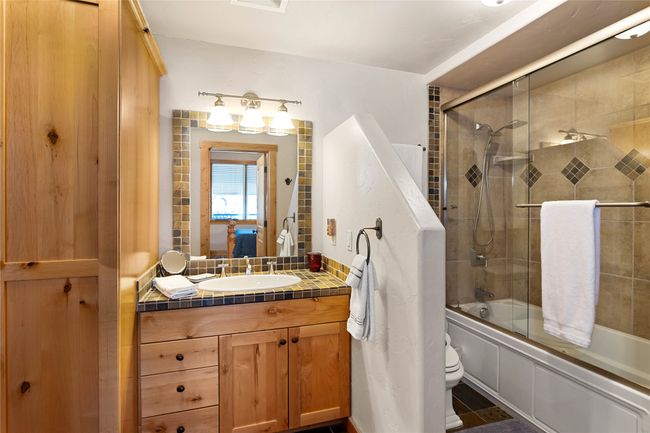 Downstairs bath with stacked washer/dryer in closet | Image 21