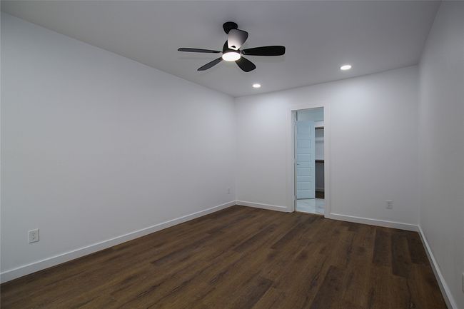 Spare room featuring a ceiling fan, baseboards, recessed lighting, and dark wood-type flooring | Image 13