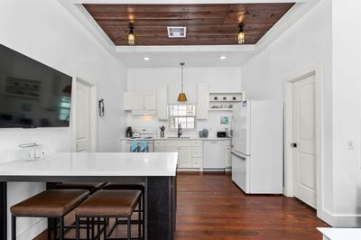 Restored hardwoods are gleaming in this cute home! Notice the reclaimed wood ceiling detail! | Image 3