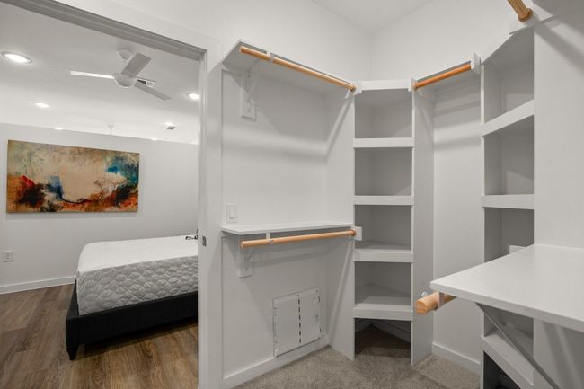 Spacious closet with wood finished floors | Image 16