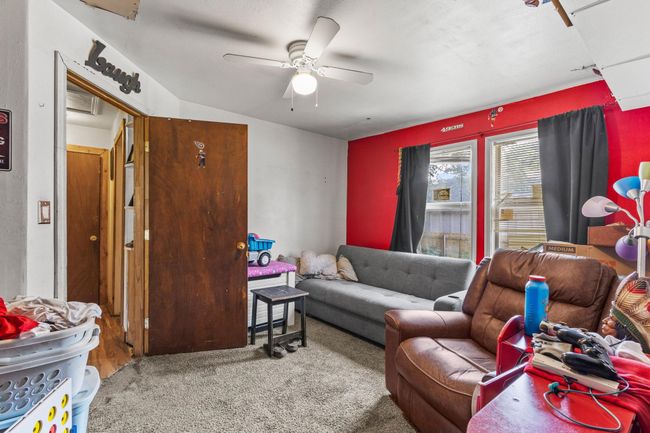 Carpeted living area featuring ceiling fan | Image 15