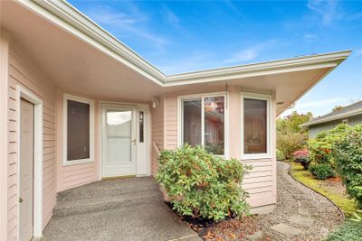 Front door entry, with the garage door to the left. With pathway to the back yard, and nicely landscaped for privacy. | Image 3