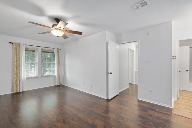 Unfurnished room with ceiling fan and wood finished floors | Image 21