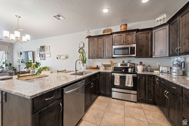 Kitchen featuring stainless steel appliances and granite countertops | Image 12