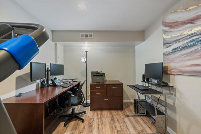 Office area with baseboards, light wood-style flooring, and visible vents | Image 34