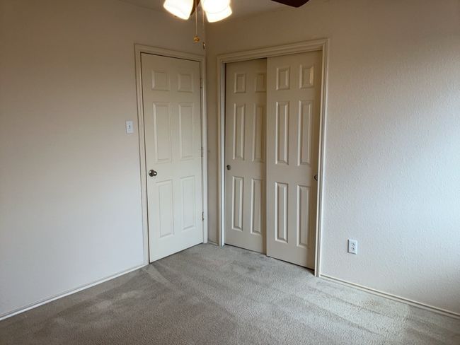 Bedroom with light colored carpet, a closet, and a ceiling fan | Image 17