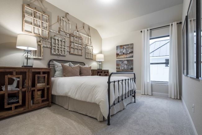 Carpeted bedroom with baseboards and lofted ceiling | Image 22