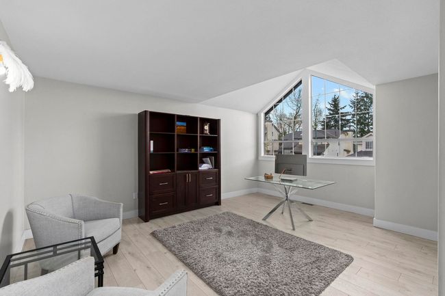 Office space with light wood-style flooring, baseboards, and lofted ceiling | Image 18