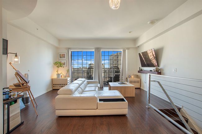 Living area with dark wood-style flooring and baseboards | Image 8