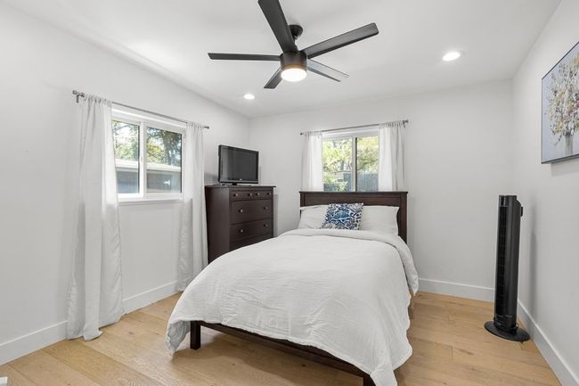 Bedroom with recessed lighting, light wood-style floors, baseboards, and ceiling fan | Image 22