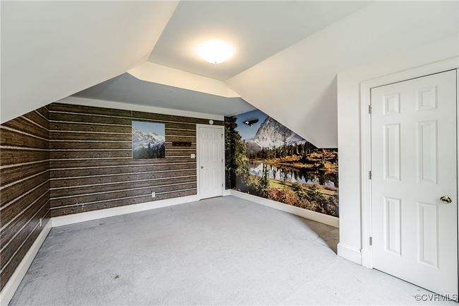 Bonus room featuring wooden walls, carpet floors, and baseboards | Image 31