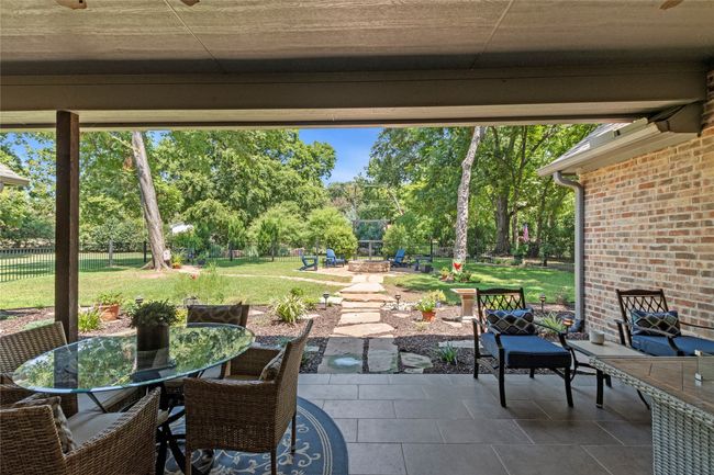 Beautifully landscaped front and back with wrought iron fenced yard. | Image 26