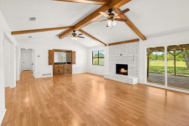 Living Area, complete with wet bar and wood burning fireplace | Image 4