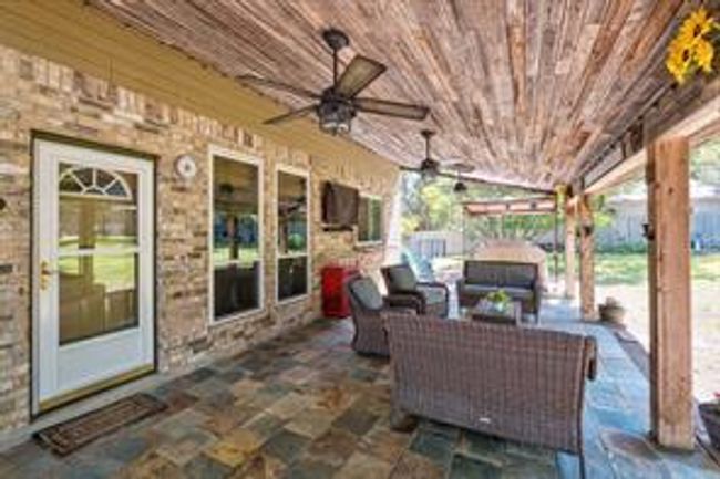 View of patio featuring an outdoor hangout area and ceiling fan | Image 33