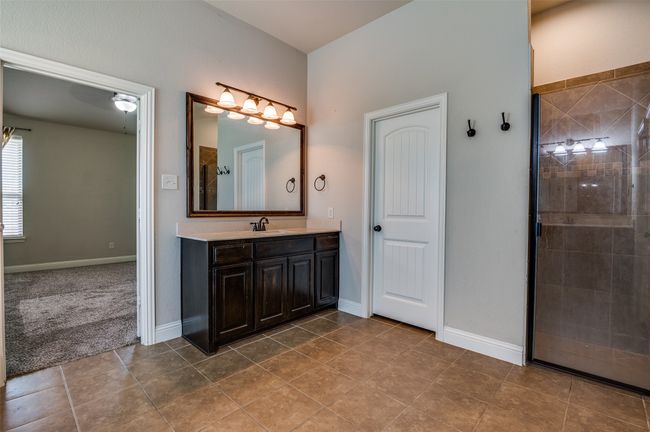 Full bathroom featuring vanity, tile patterned floors, and a tile shower | Image 17
