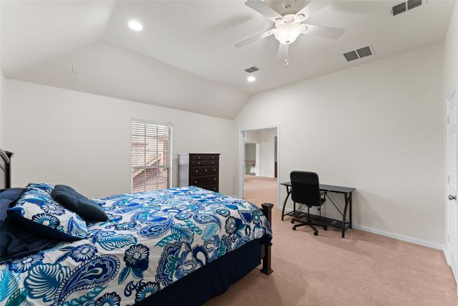 Bedroom with light colored carpet, lofted ceiling, ceiling fan, and recessed lighting | Image 24