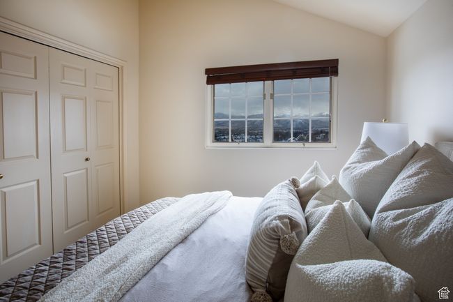 Bedroom featuring a closet and vaulted ceiling | Image 12