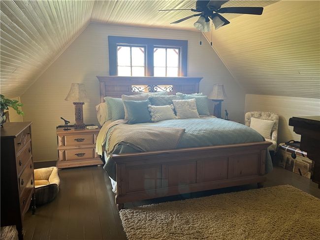 Upstairs bedroom with wooden ceiling, wood flooring, and lofted ceiling | Image 16