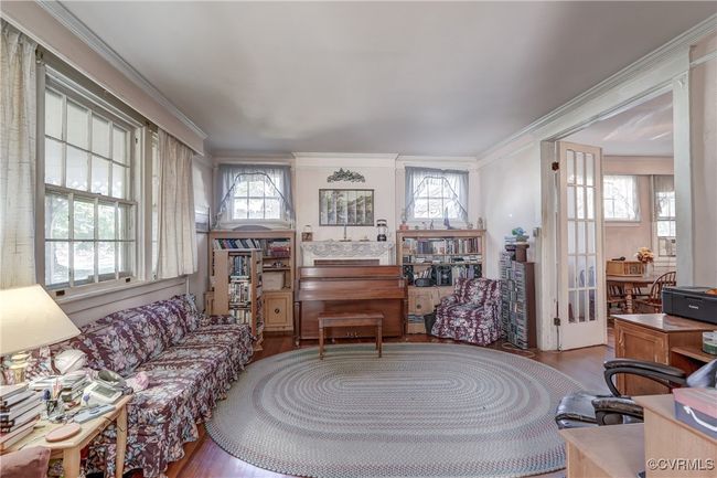 Living area with a healthy amount of sunlight and crown molding | Image 9
