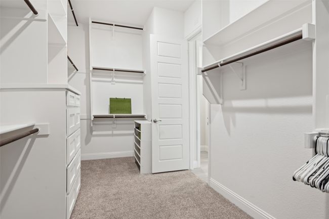 Walk in closet featuring light carpet | Image 17