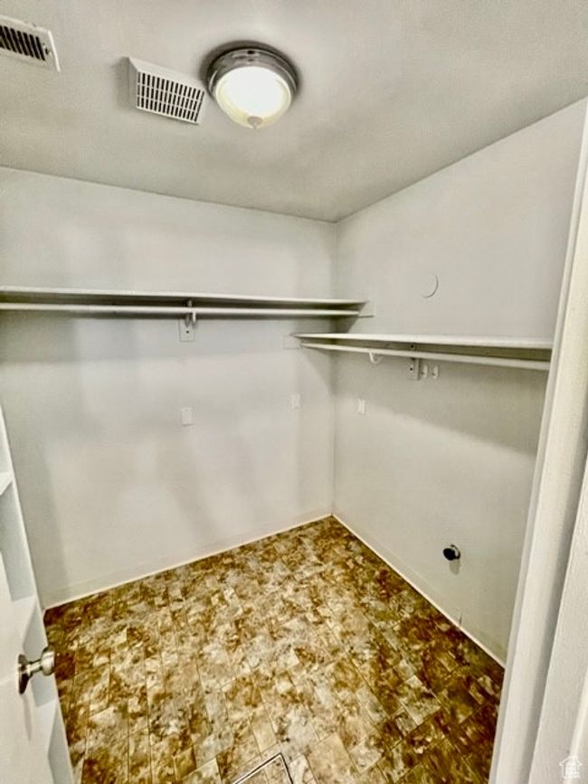 Walk in closet featuring visible vents | Image 15