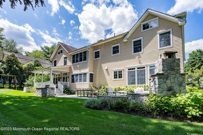 Private tree-lined yard and fantastic outdoor living with covered porch and patio | Image 3