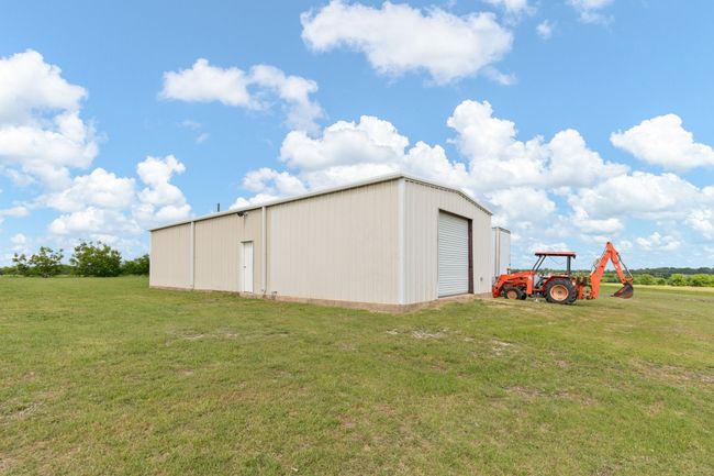 For the workshop enthusiast, discover your happy place in a 24X60, garage parking, insulated, 12" concrete slab equipped with an air compressor piped with 2 hose reels bolted on its own concrete slab just outside. Percolating septic, 1500 gallon for room to grow, 500 gallon owned & buried propane tank, RV hookup & Ag Exempt. (Tractor does not convey) | Image 36