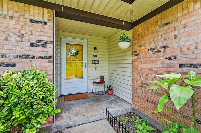 View of exterior entry featuring brick siding and covered porch | Image 4