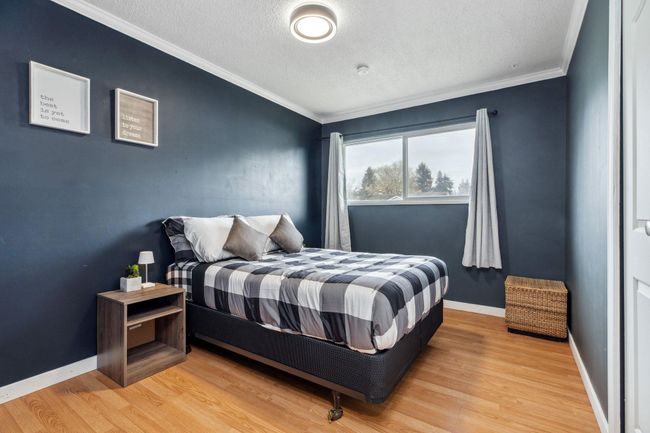 Bedroom featuring ornamental molding, light wood finished floors, and a textured ceiling | Image 20