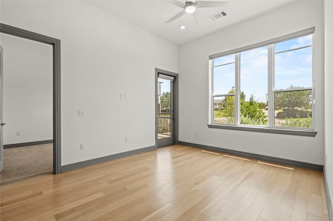 Unfurnished room featuring ceiling fan, light wood finished floors, baseboards, and recessed lighting | Image 11