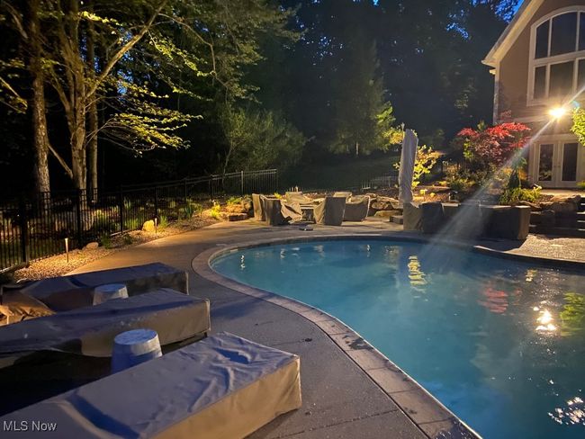 Pool at twilight featuring fence, french doors, a fenced in pool, and a patio area | Image 46