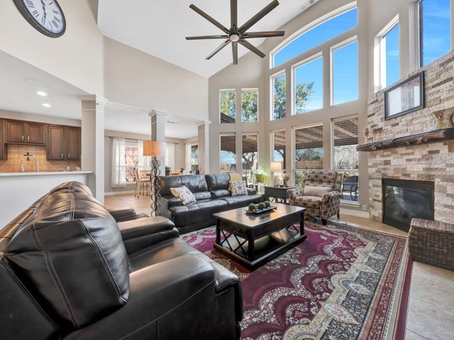Living room with tile floors, a fireplace, and ornate columns | Image 21
