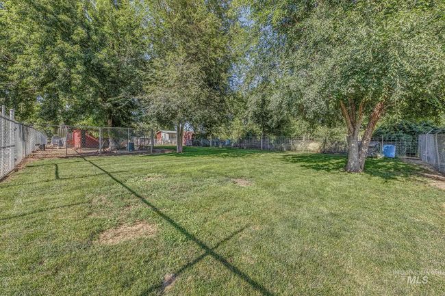 View of fenced backyard | Image 21