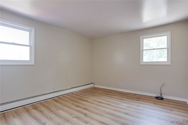 3rd bedroom featuring a baseboard radiator and light wood-type flooring | Image 16