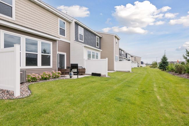 A large, level lawn spalls out from the back of the home. | Image 18