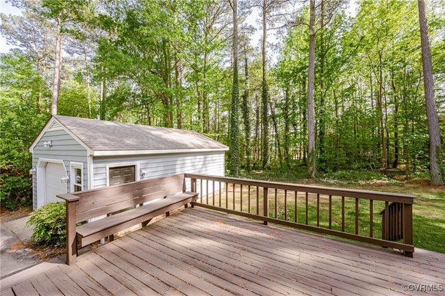 Deck with a detached garage and an outbuilding | Image 44