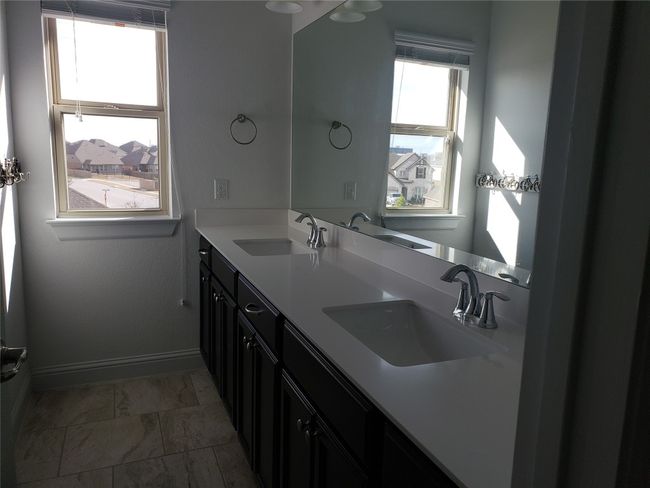 Full bathroom featuring double vanity and baseboards | Image 17