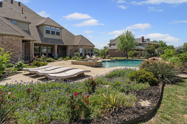 View of pool with a patio area and a pool with connected hot tub | Image 33