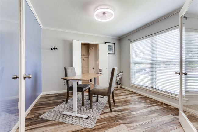 Dining room featuring ornamental molding, light wood finished floors, and french doors | Image 13