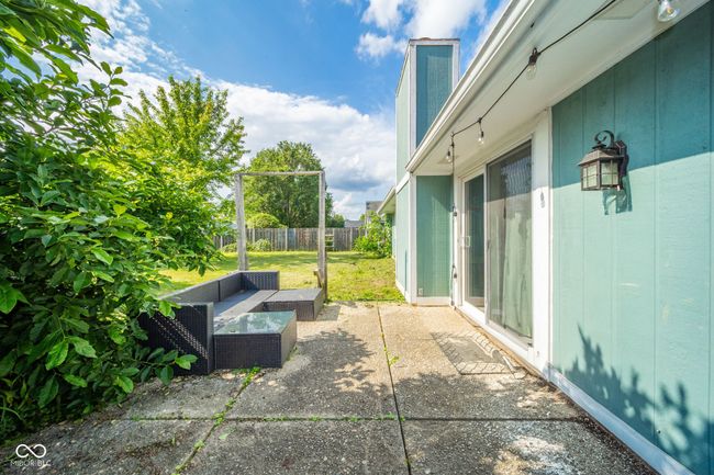 fenced backyard with an outdoor living space and a patio area | Image 30