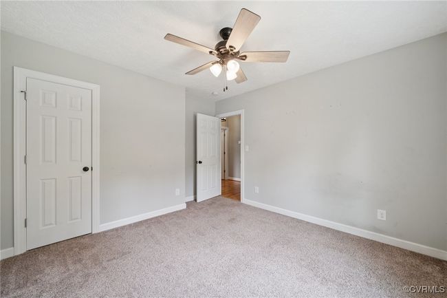 Unfurnished bedroom featuring carpet floors, baseboards, and ceiling fan | Image 21