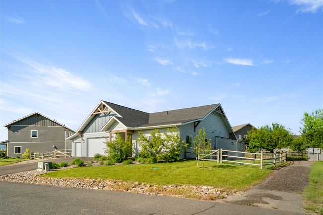 View of front of property featuring board and batten siding, an attached garage, driveway, and roof with shingles | Image 42